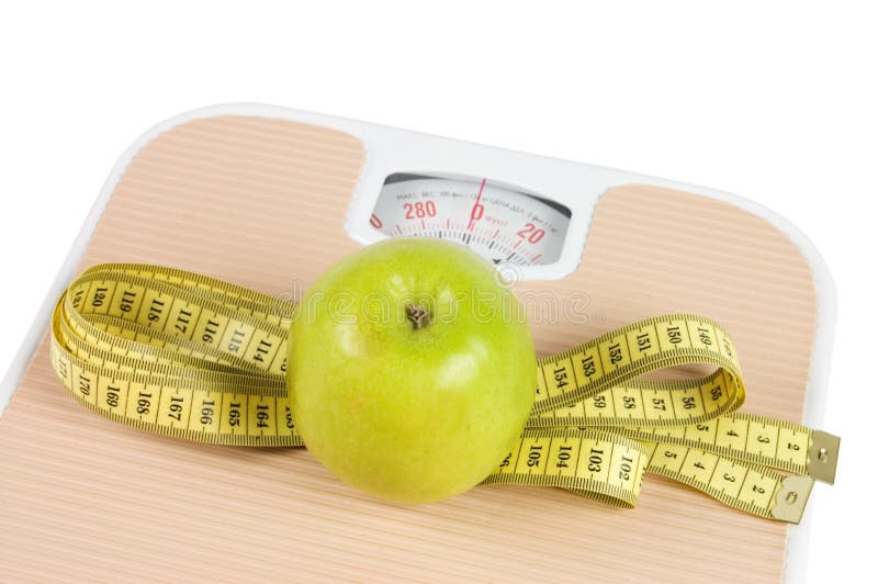 Proper nutrition for lose weight. Scale, measuring tape, apple on pink  background top view space for text Stock Photo