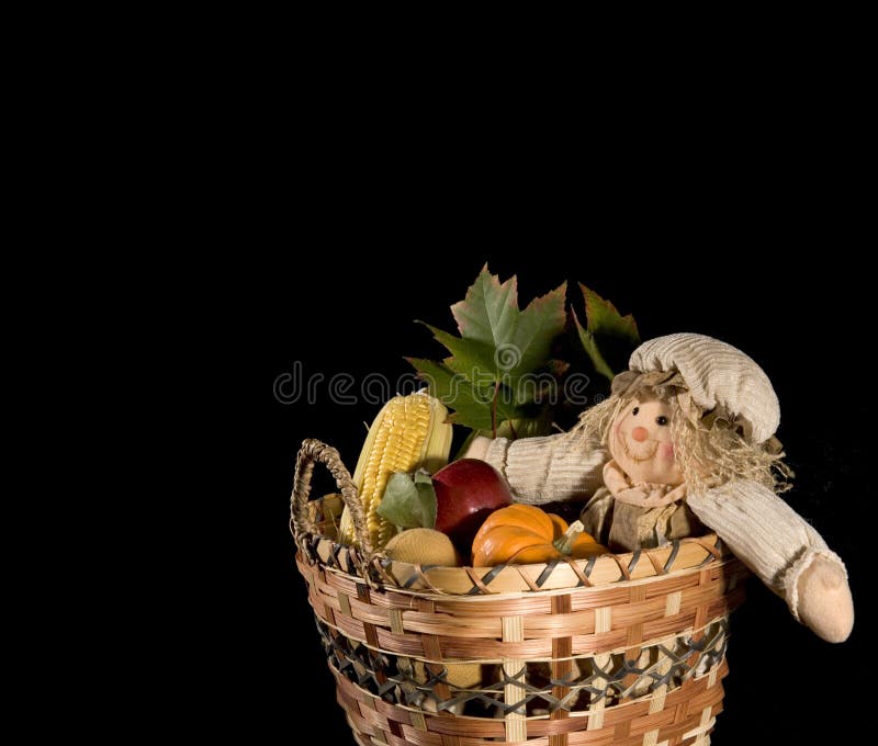 Scarecrow doll in harvest basket