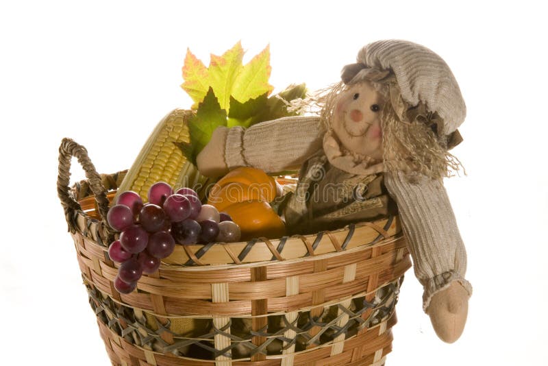 Scarecrow doll in harvest basket