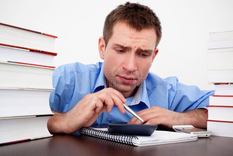 Scared male student count on calculator stock photos