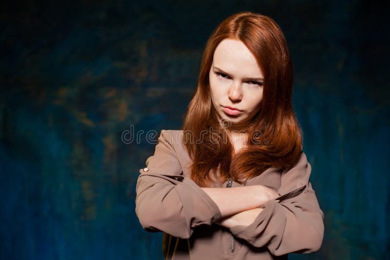 Scared red-haired woman posing