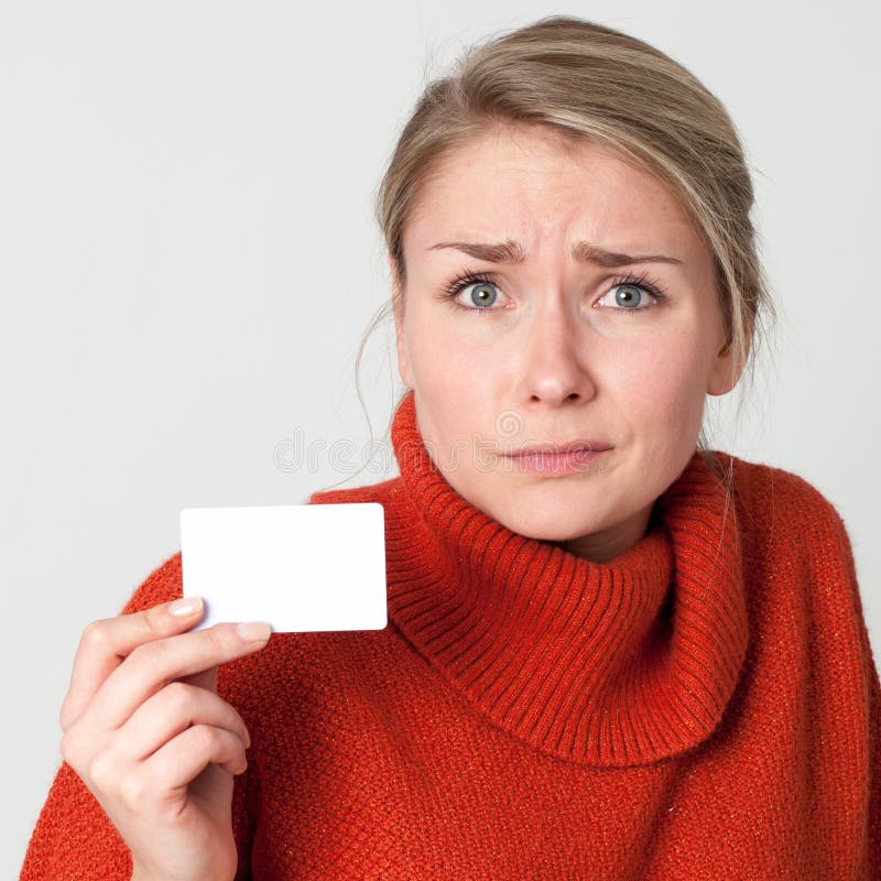 Scared woman holding business or credit card for presentation stock photo Scared woman holding business or credit card for presentation stock photo