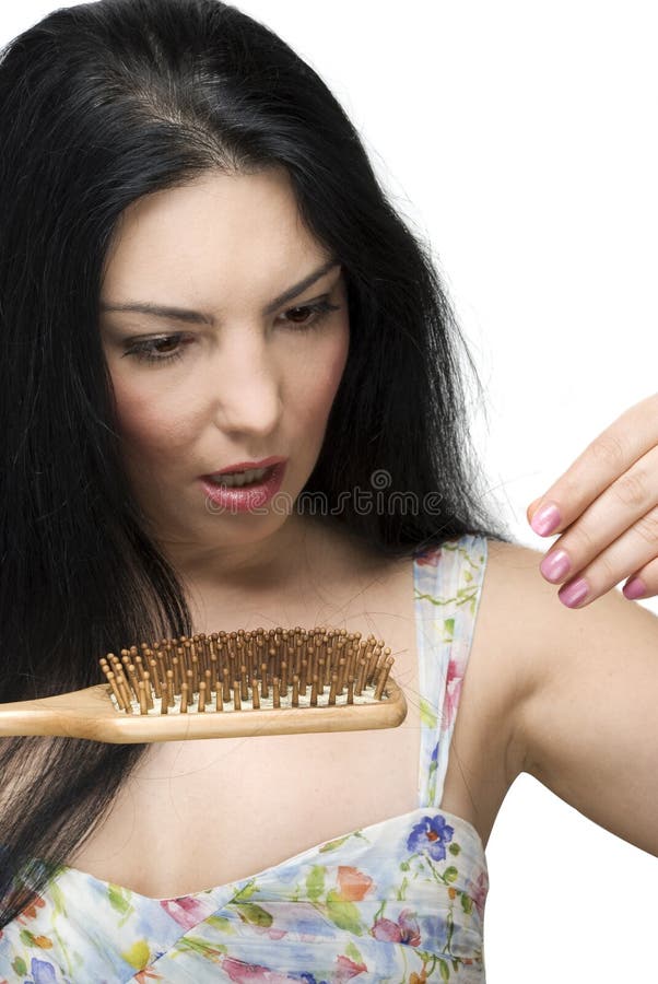 Brunette woman with long hair collecting hairs on the brush hair and being very shocked and scared to lose her hair isolated on white background.Check also. Brunette woman with long hair collecting hairs on the brush hair and being very shocked and scared to lose her hair isolated on white background.Check also