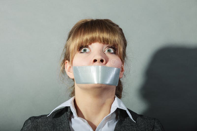 Scared woman with mouth taped shut. 