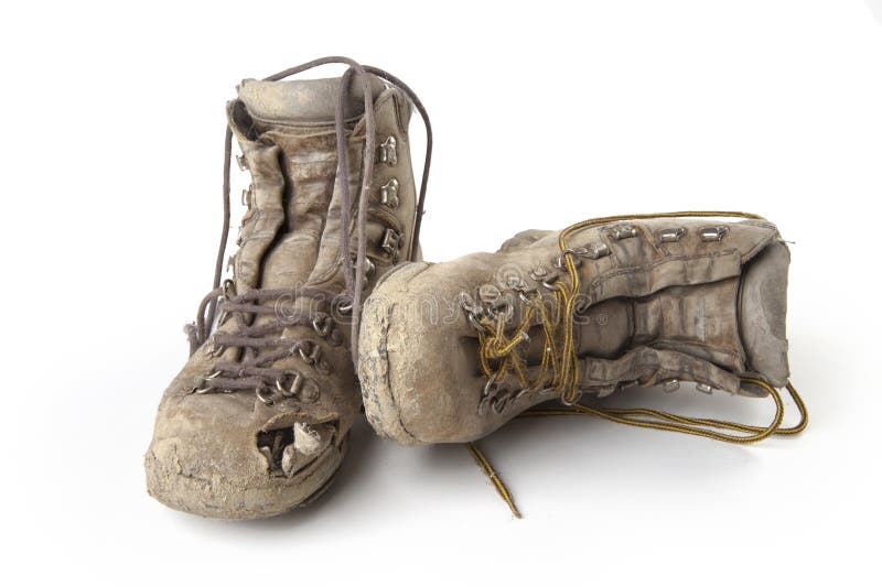 Very used mountaineering boots on a white background. Very used mountaineering boots on a white background