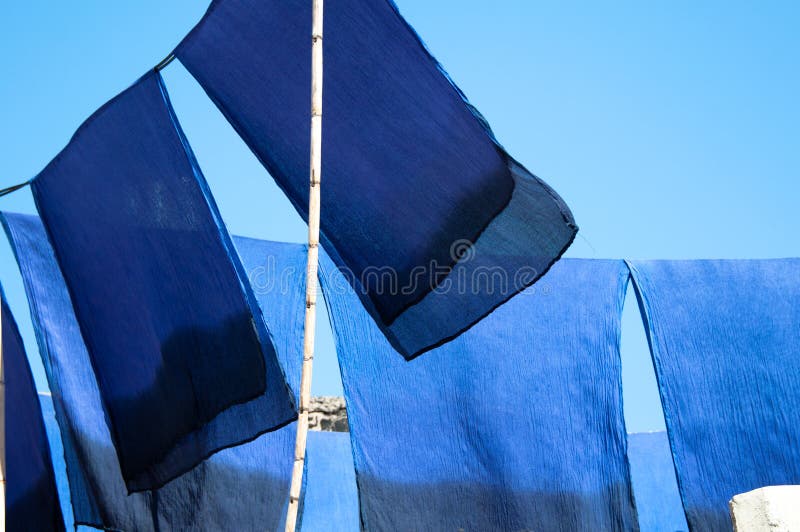 Scarves drying in the sun stock images
