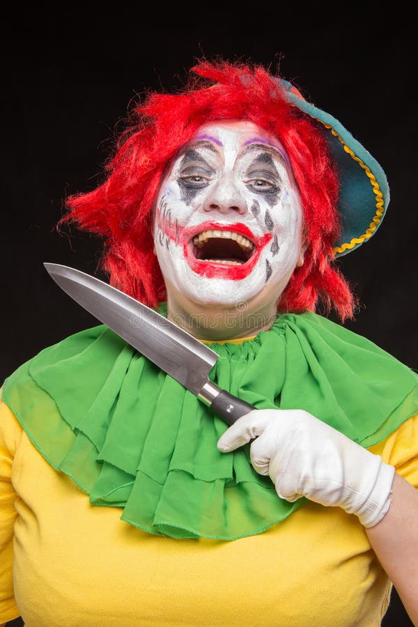 Download Scary Clown Joker With A Smile And Red Hair With A Big Knife On Stock Photo - Image of circus, creepy: 77379840