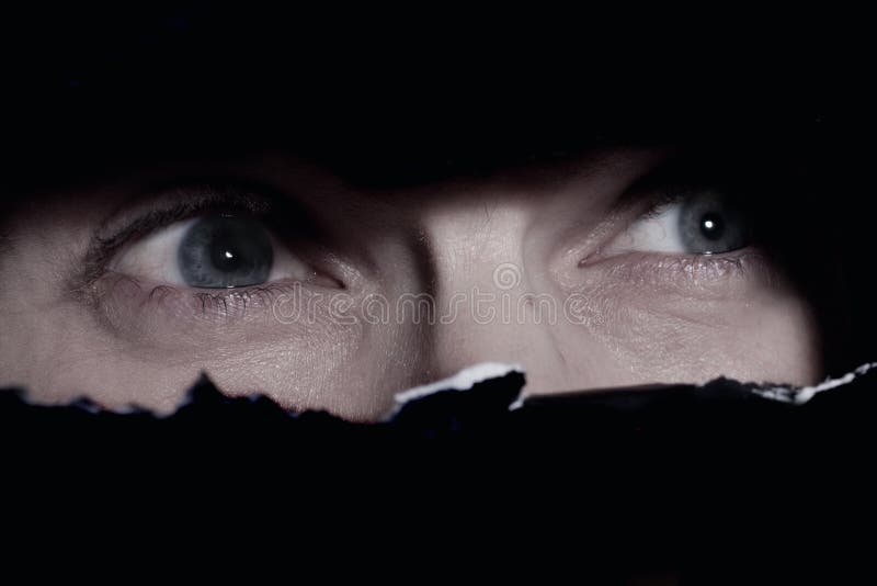 Scary eyes of a man spying