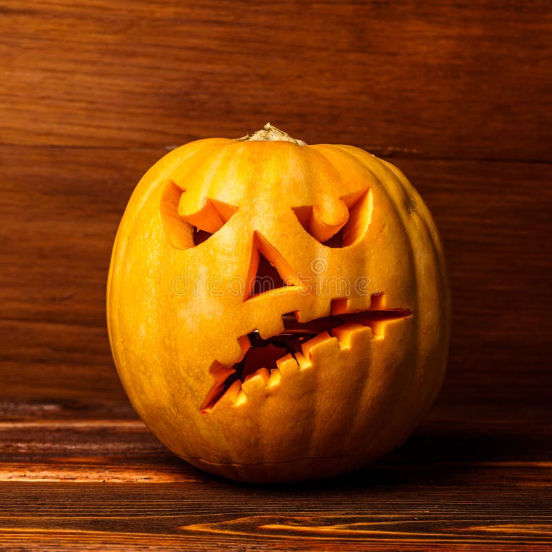 Scary Halloween Pumpkins on Wooden Background . Scary Glowing Faces ...