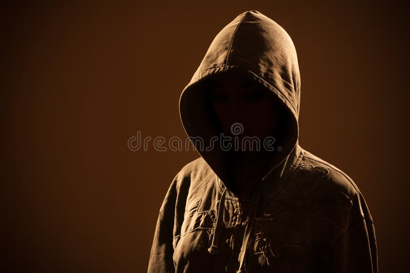 Scary evil woman with hood in darkness. Negative moody stock images, royalty-free photos and pictures