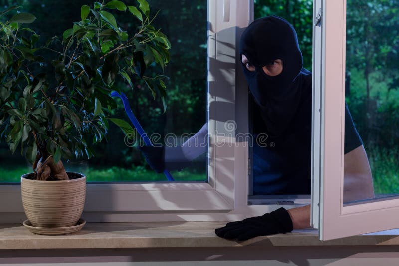 Horizontal view of burglar with a crowbar. Horizontal view of burglar with a crowbar