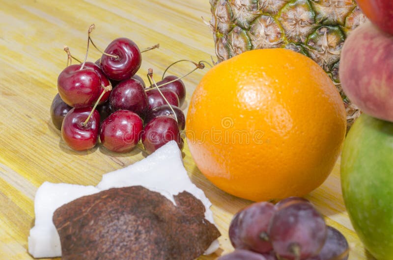 Scattered cherries over yellow wood. stock image Scattered cherries over yellow wood. stock image