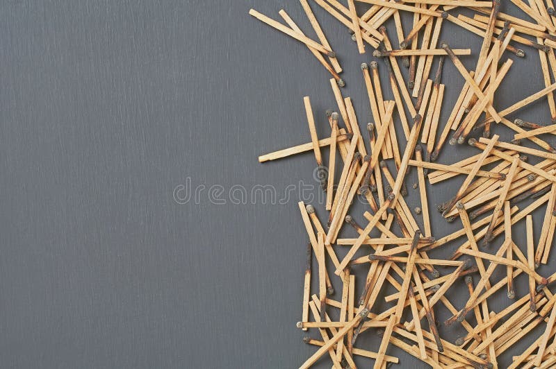 Scattered many used matchsticks with burnt sulfur on dark concrete table on kitchen. Space for text