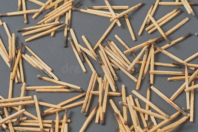Scattered many used matchsticks with burnt sulfur on dark concrete table on kitchen. Top view