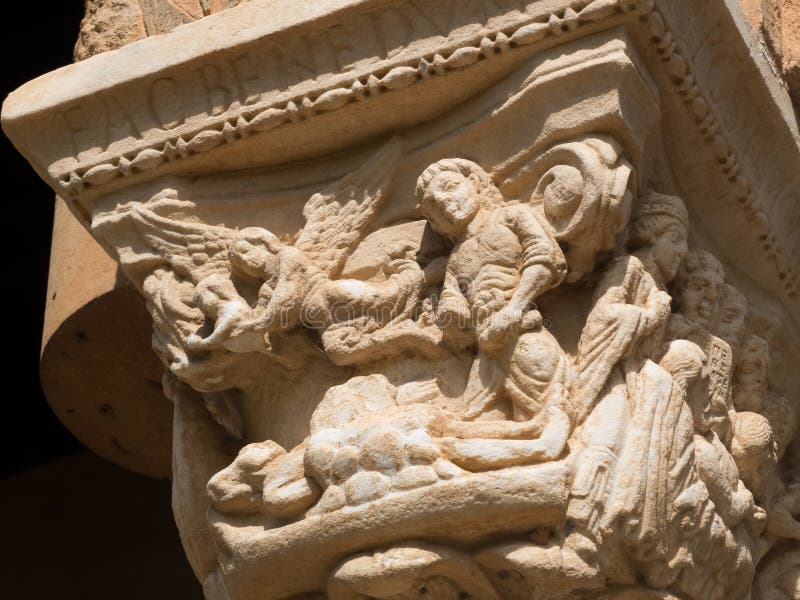 Monreale, Sicily, Italy-September 14,2019 : Narrative Capital of a column from St Mary Cathedral Basilica in the cloister of Monreale Basilica . A narrative religious scene is represented. Monreale, Sicily, Italy-September 14,2019 : Narrative Capital of a column from St Mary Cathedral Basilica in the cloister of Monreale Basilica . A narrative religious scene is represented