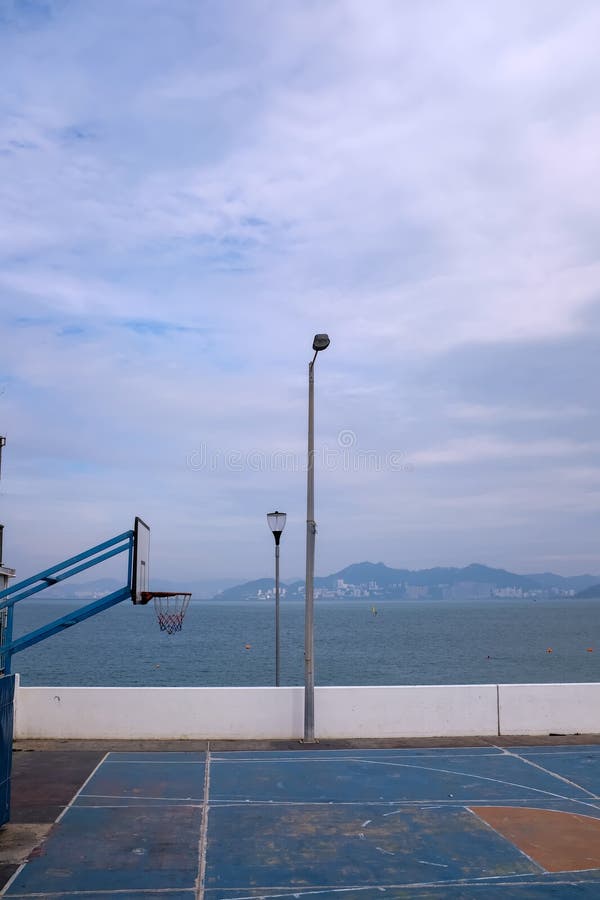The Scene of Outdoor Basketball Court with Seascape and Skyscape Stock The Scene of Outdoor Basketball Court with Seascape and Skyscape Stock
