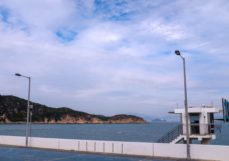 The Scene of Outdoor Basketball Court with Seascape and Skyscape Stock The Scene of Outdoor Basketball Court with Seascape and Skyscape Stock