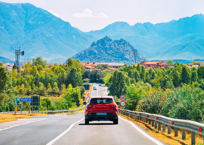 Scenery with red car on highway in Cagliari Sardinia hills royalty free stock images Scenery with red car on highway in Cagliari Sardinia hills royalty free stock images