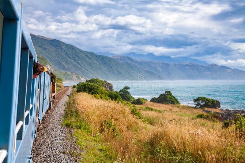 Scenic coastal railway journey along Pacific ocean coast in New Zealand