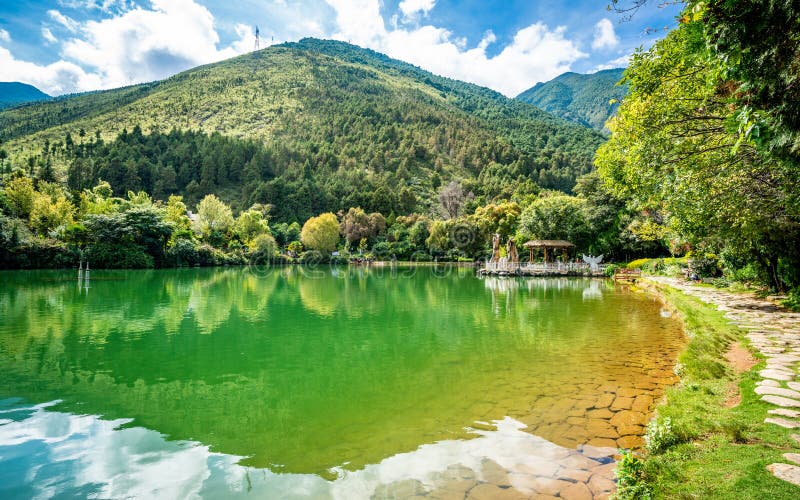 Scenic crescent moon lake pool view with Cangshan mountain water reflection in the Butterfly spring park Dali Yunnan China