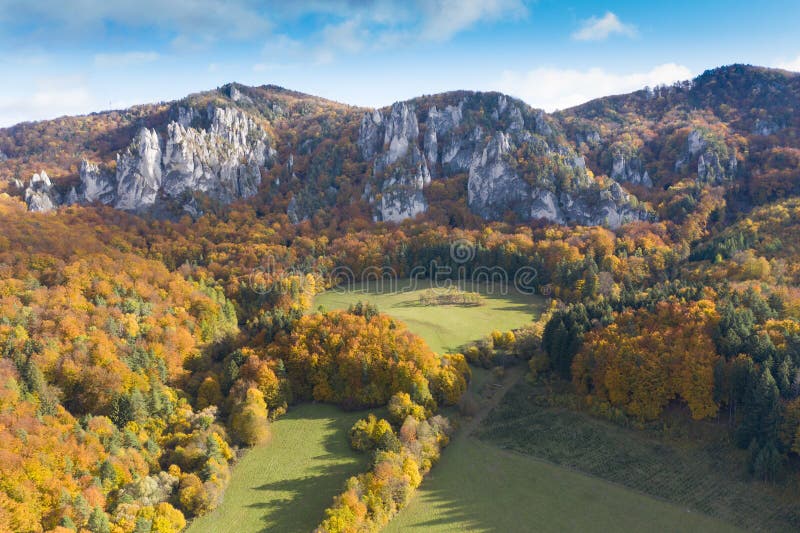 Scenic landscape in Sulov, Slovakia, on beautiful autumn sunrise with colorful leaves on trees in forest and bizarre pointy rocks