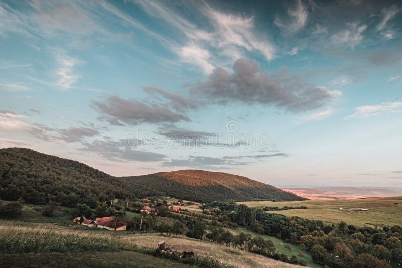 Scenic shot of hills on wide greenfields royalty free stock photography