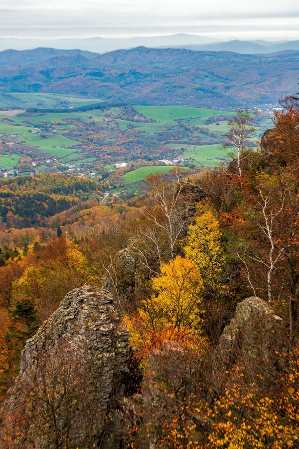 Scenic valley with colorful autumn trees. Sitno hill in Stiavnicke Vrchy, Slovakia.