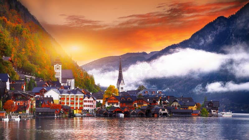 Scenic view of famous Hallstatt mountain village with Hallstatter lake. Foggy autumn sunrise on Hallstatt lake