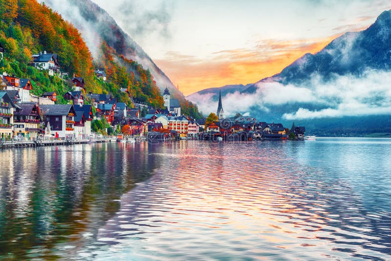 Scenic view of famous Hallstatt mountain village with Hallstatter lake. Foggy autumn sunrise on Hallstatt lake