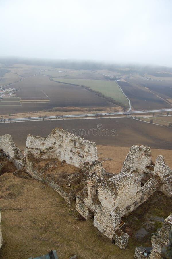 Scenic view of old stone european castle with grey fog on background