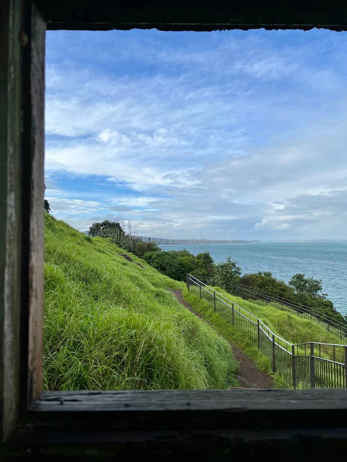Scenic View of a Rolling Hill and the Ocean in the Background, Captured
