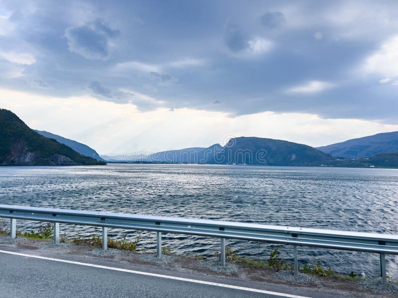 Dramatic landscape of saguenay fjord with sun rays piercing through the cloudy sky, creating a scenic view stock photography