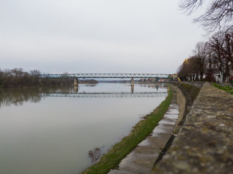 Scenic view of Sava river from Gradiška quay during overcast day in Gradiška, Bosnia and Herzegovina. Overcast grove stock images, royalty-free photos and pictures