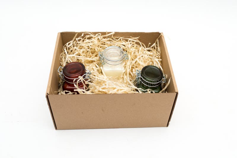 Scented Candles in Colored Glass Jars in a Cardboard Box with Packaging