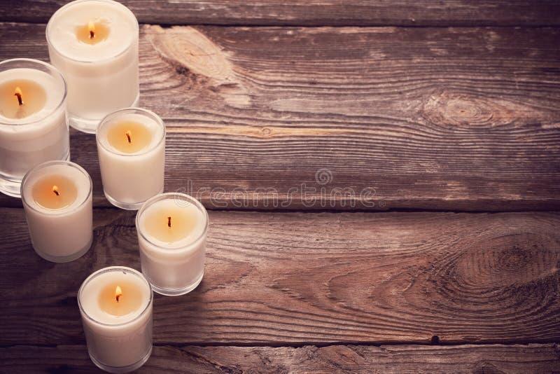 Scented candles on wooden background