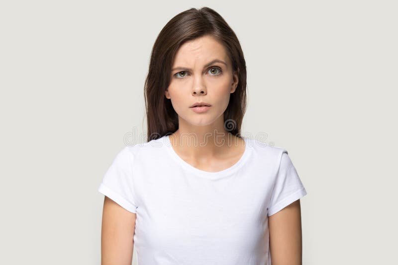 Sceptic suspicious millennial woman pose on grey studio background stock images Sceptic suspicious millennial woman pose on grey studio background stock images