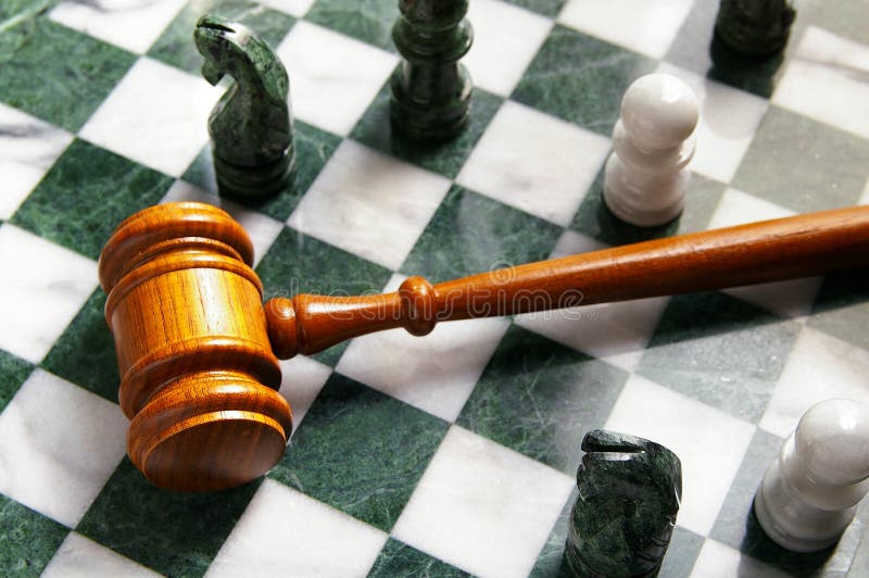 Judges law gavel on a chess board, from above. Judges law gavel on a chess board, from above