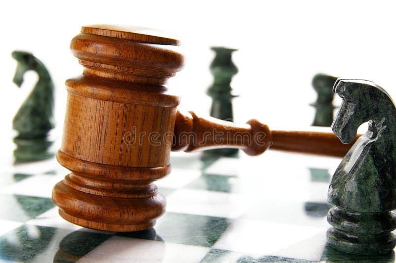 Law gavel on a chess board with pieces. Law gavel on a chess board with pieces