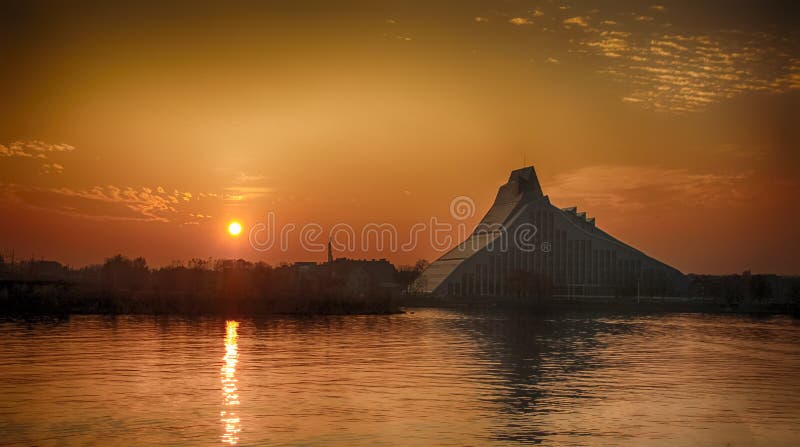Silhouette of the Latvian National Library located in Riga, the capital of Latvia. The view of the river Daugava. Silhouette of the Latvian National Library located in Riga, the capital of Latvia. The view of the river Daugava.