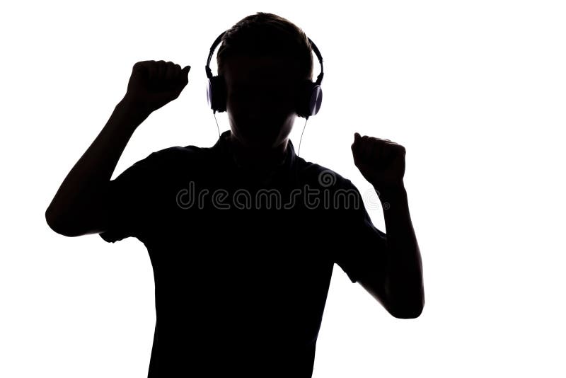 Schattenbild des Jugendlichen hörend Musik in den Kopfhörern und im danc lizenzfreie stockfotografie Schattenbild des Jugendlichen hörend Musik in den Kopfhörern und im danc lizenzfreie stockfotografie