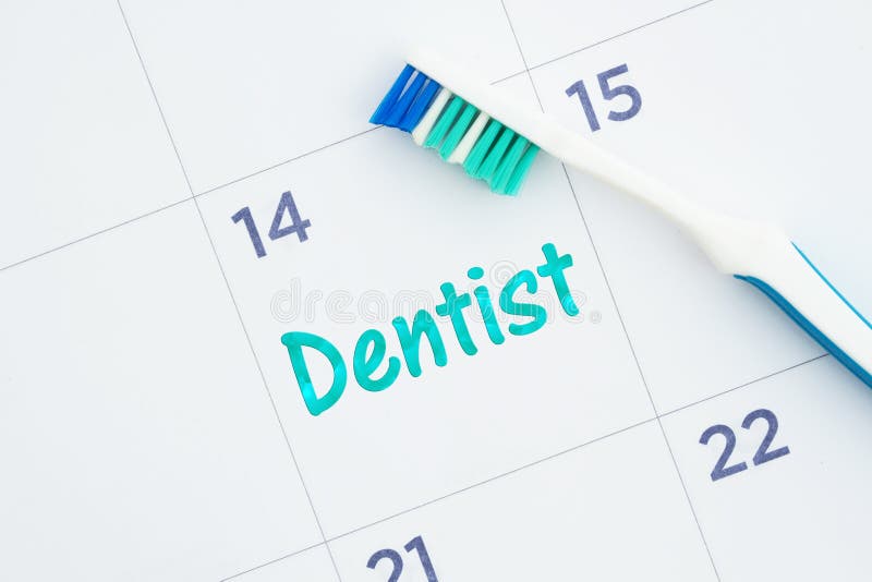Schedule a dentist appointment message on a calendar with a toothbrush stock photography