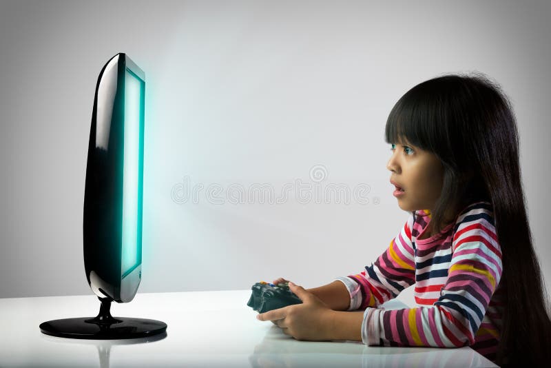 Little girl playing computer games, Kids addicted to the game concept. Little girl playing computer games, Kids addicted to the game concept