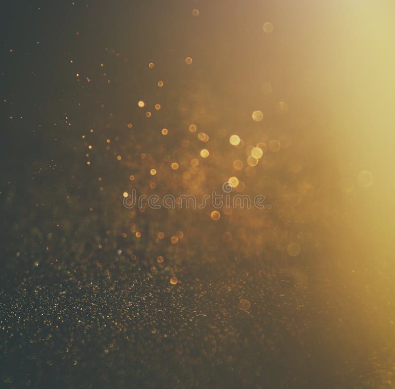 Schitter uitstekende lichtenachtergrond Goud en zwarte defocused stock fotografie Schitter uitstekende lichtenachtergrond Goud en zwarte defocused stock fotografie