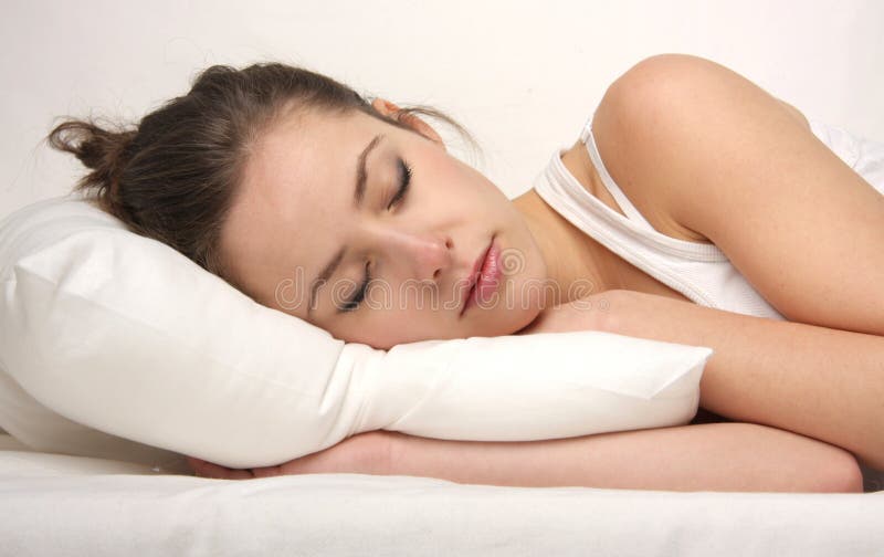 Beautiful woman lying and sleeping on the snowy pillow. Beautiful woman lying and sleeping on the snowy pillow
