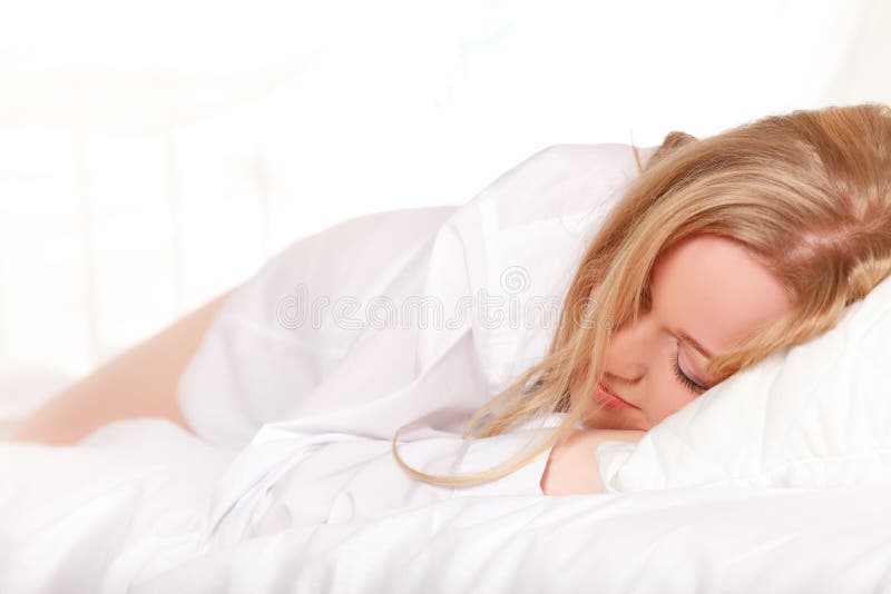 Sleeping blonde woman in bed at morning. Sleeping blonde woman in bed at morning