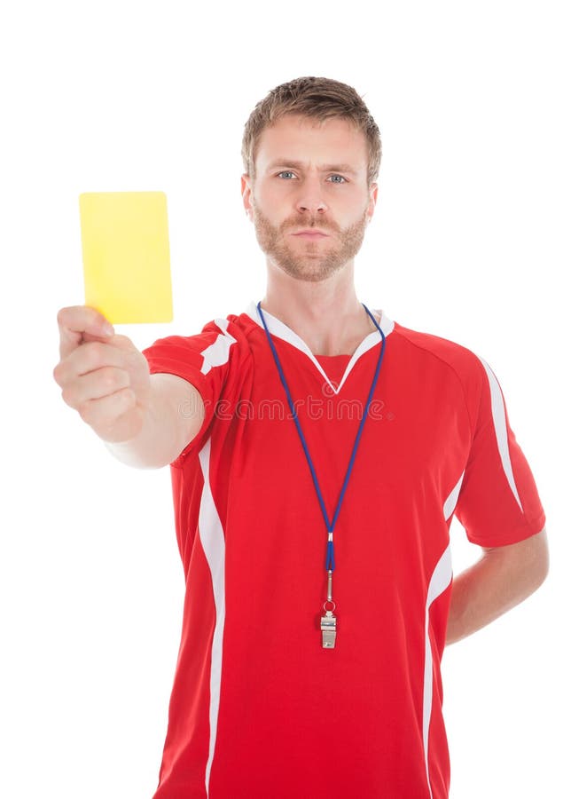 Schlagpfeife des Referenten beim Zeigen der gelben Karte lizenzfreies stockfoto Schlagpfeife des Referenten beim Zeigen der gelben Karte lizenzfreies stockfoto