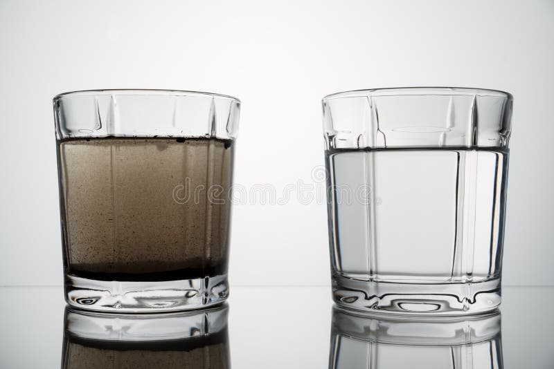 Schließen Sie herauf Gläser mit sauberem und Schmutzwasser