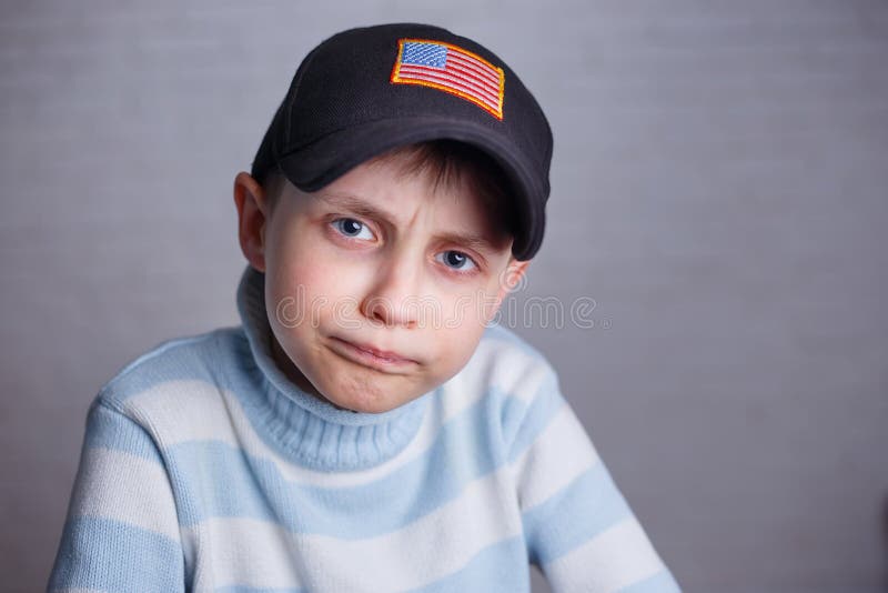 Schließen Sie herauf Porträt des netten Jungen in der Baseballmütze mit USA-Flagge stri stockfotografie Schließen Sie herauf Porträt des netten Jungen in der Baseballmütze mit USA-Flagge stri stockfotografie
