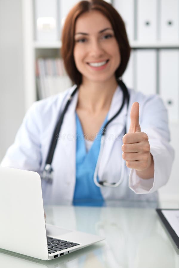 Schließen Sie oben von den Ärztindaumen oben Glücklicher netter lächelnder Brunettearzt bereit, Patienten zu überprüfen medizin lizenzfreie stockfotos