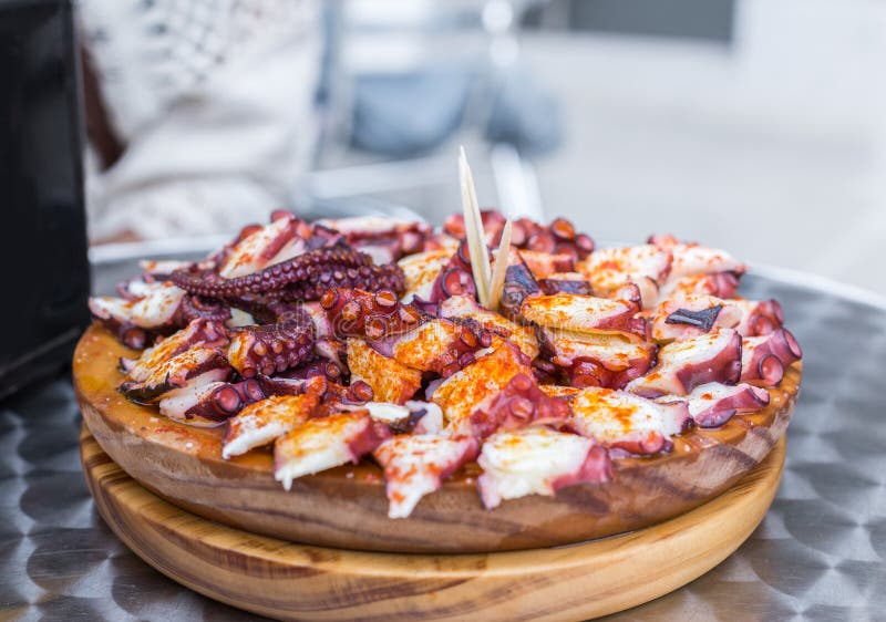 Schließen Sie oben von der geschmackvollen hölzernen Platte der galizische Art gekochten Krake mit Paprika und Olivenöl Pulpo ein